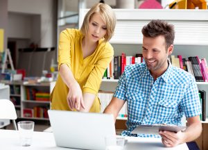Man-and-woman-looking-at-laptop-SS-144275518